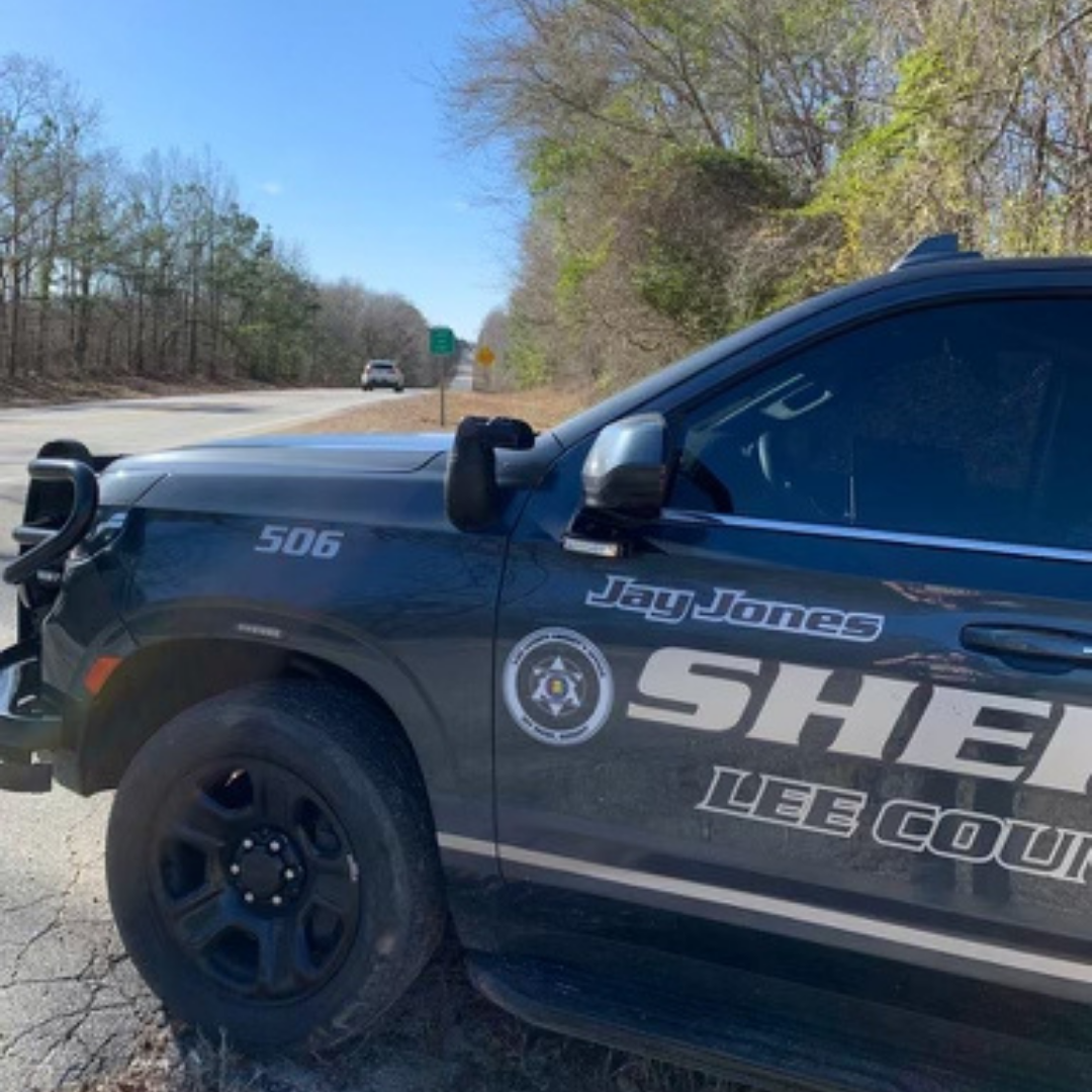 Lee County Sheriff patrol vehicle parked beside a rural highway