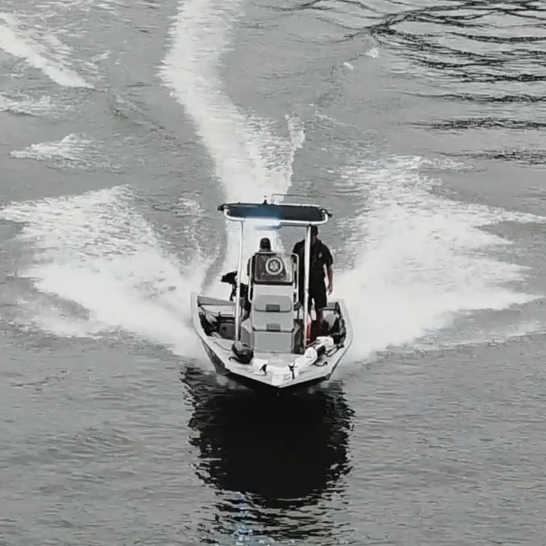 Sheriff's patrol boat cutting across a lake